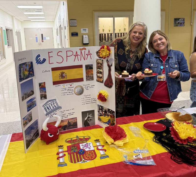 Heidi Furman, left, and Dr. Estefania Becker display students’ country projects.